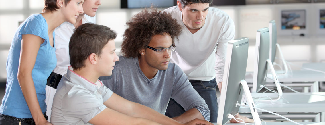  A diverse group of young individuals focused on their computers