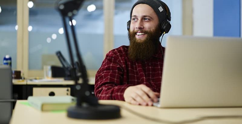 Man at laptop smiling