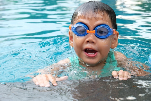 Young boy swimming in pool