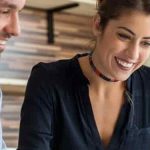 Male and female looking at a laptop