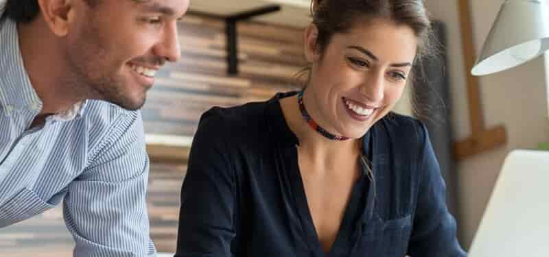 Male and female looking at a laptop